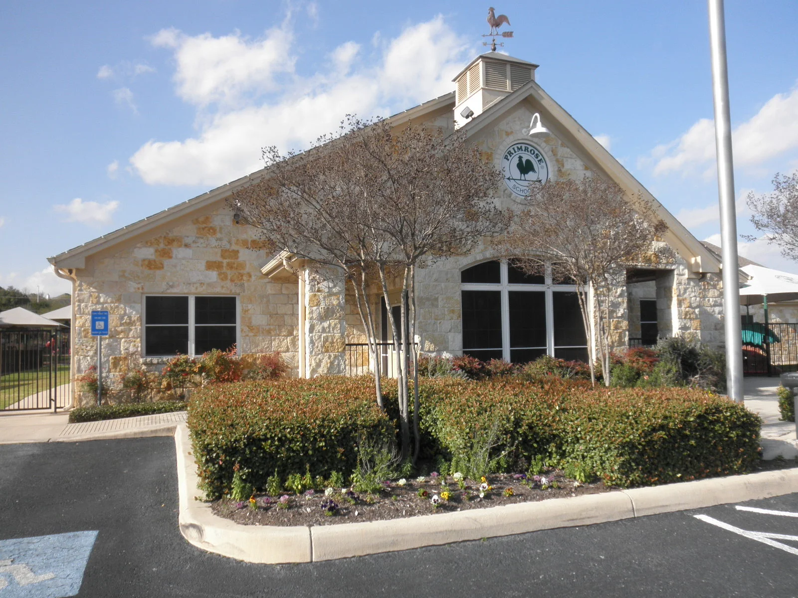 Black-framed windows installed on limestone institutional building with cupola