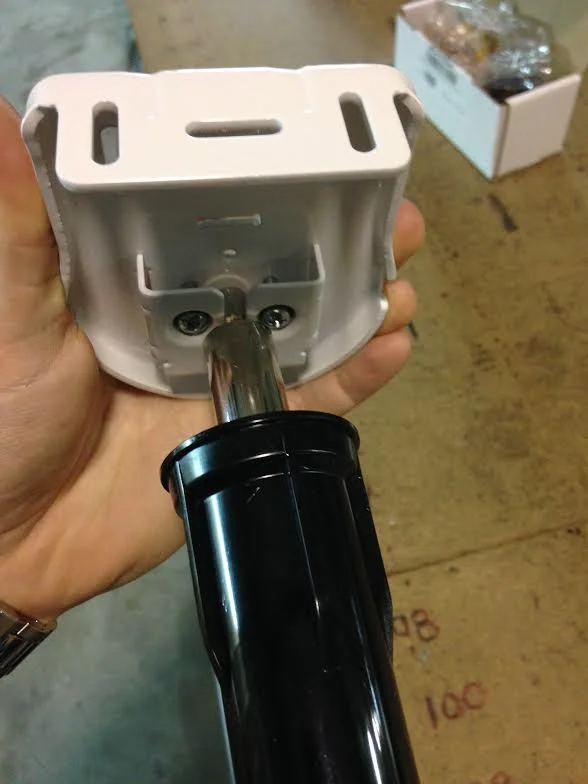 White solar screen end pin bracket with black cylindrical pin component for window installation